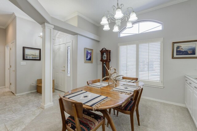 carpeted dining space featuring an inviting chandelier, ornamental molding, plenty of natural light, and decorative columns