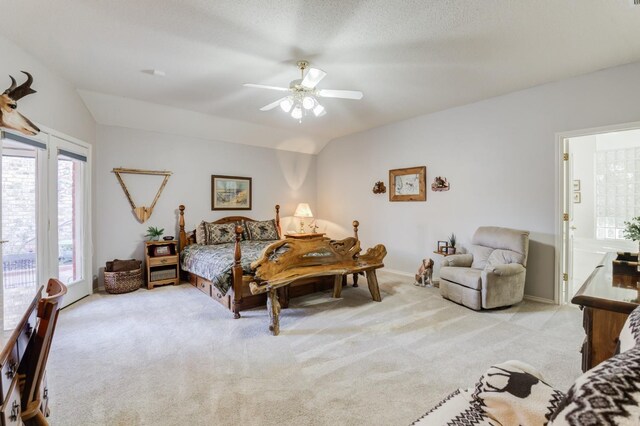 carpeted bedroom with vaulted ceiling, access to exterior, ceiling fan, and ensuite bath