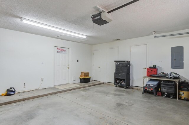 garage featuring a garage door opener and electric panel