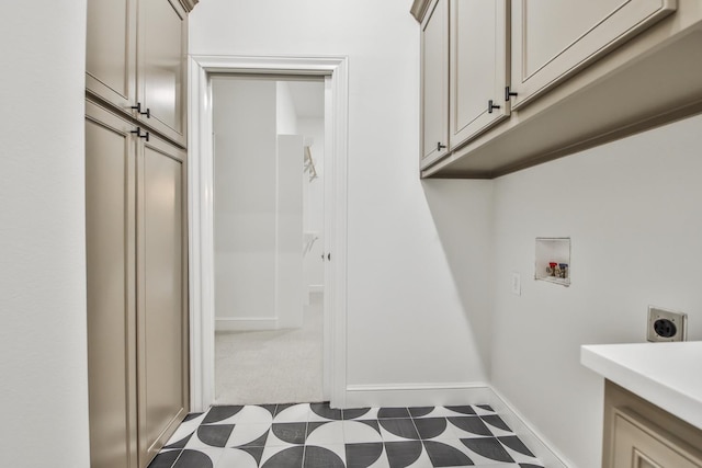 laundry area featuring cabinets, hookup for a washing machine, and hookup for an electric dryer