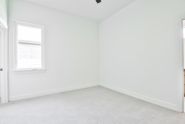 empty room with light carpet and ceiling fan