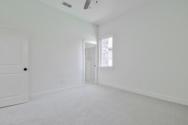 carpeted spare room with ceiling fan