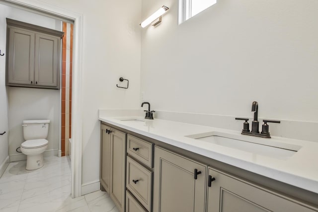 bathroom featuring vanity and toilet