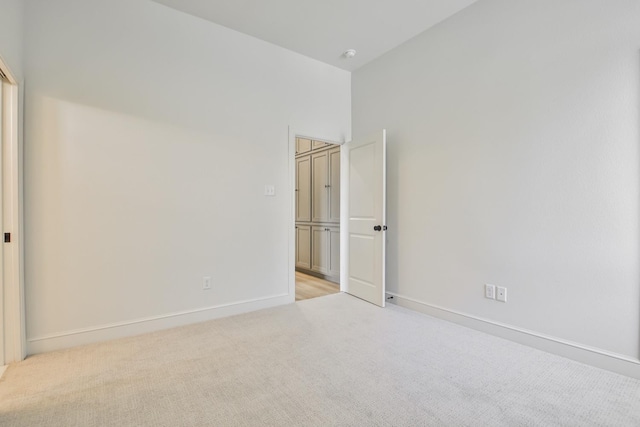 unfurnished bedroom featuring light carpet