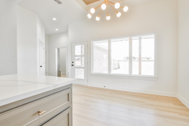 interior space featuring a chandelier and light hardwood / wood-style flooring