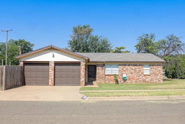 ranch-style home with a garage and a front lawn