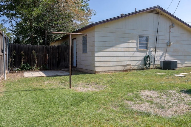 view of home's exterior featuring central AC unit and a lawn