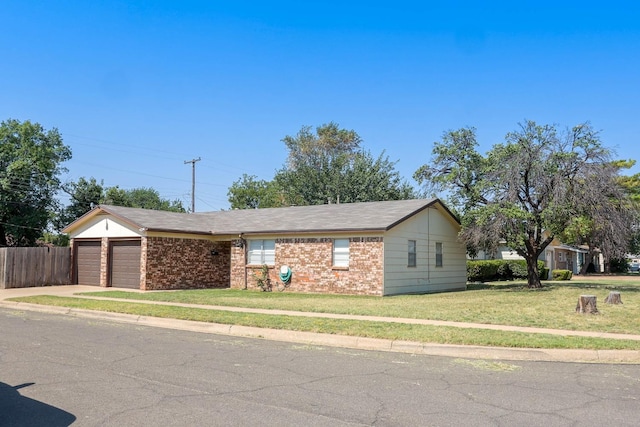 ranch-style home featuring a garage and a front yard