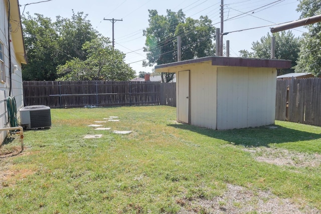 view of yard with central AC and a shed