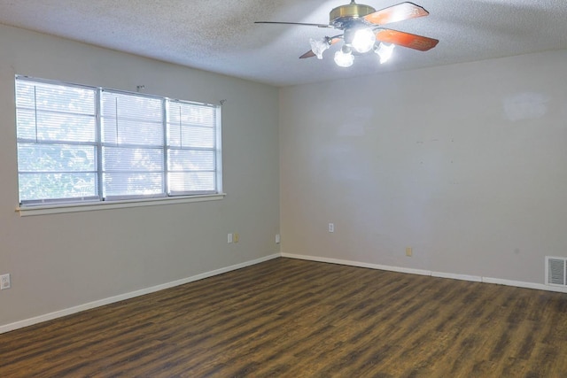 unfurnished room featuring dark hardwood / wood-style flooring, ceiling fan, and a textured ceiling