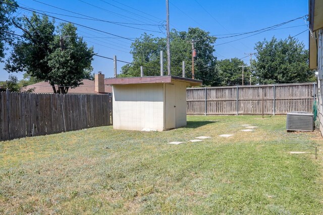 view of yard with cooling unit and a storage unit