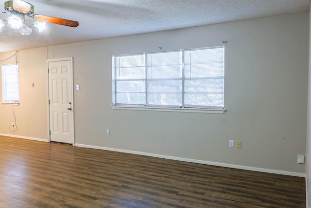 spare room featuring ceiling fan, dark wood-type flooring, and a textured ceiling