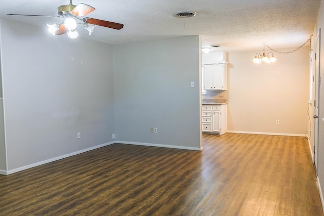 unfurnished room with hardwood / wood-style flooring, ceiling fan with notable chandelier, and a textured ceiling