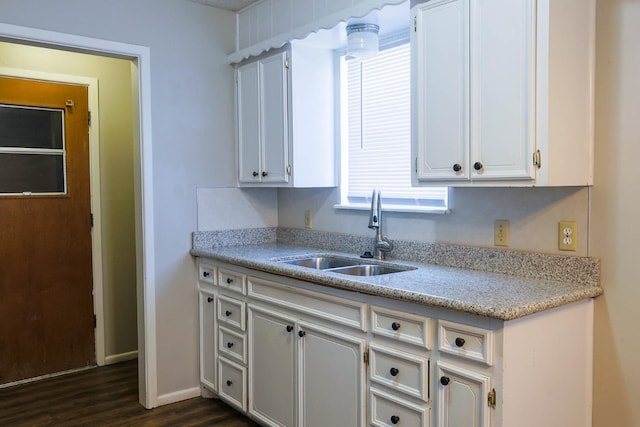 kitchen with white cabinetry, sink, and dark hardwood / wood-style flooring