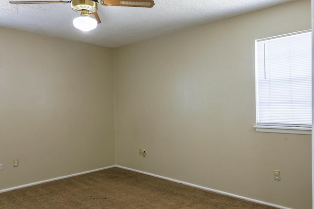 empty room with carpet flooring and ceiling fan