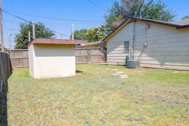 view of yard with cooling unit and a shed