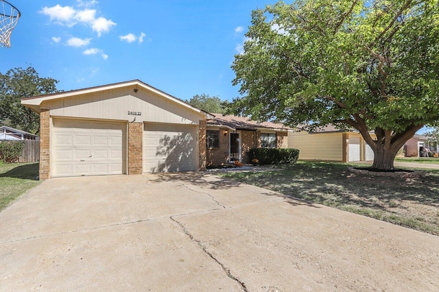 5408 22nd St, Lubbock, TX 79407 - ranch-style house with brick siding, a garage, and concrete driveway