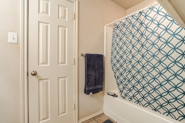 bathroom with tile patterned floors and shower / bathtub combination with curtain