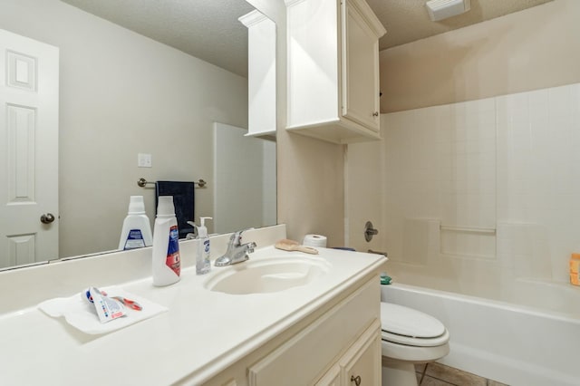 full bathroom with shower / bathing tub combination, vanity, toilet, tile patterned floors, and a textured ceiling