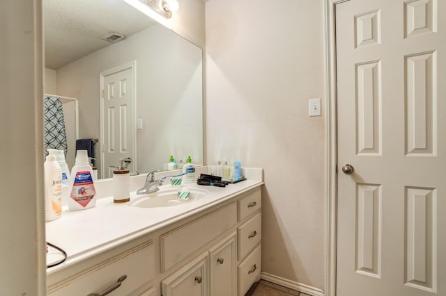 bathroom featuring vanity and a textured ceiling