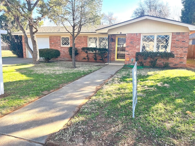 ranch-style house with a garage and a front yard