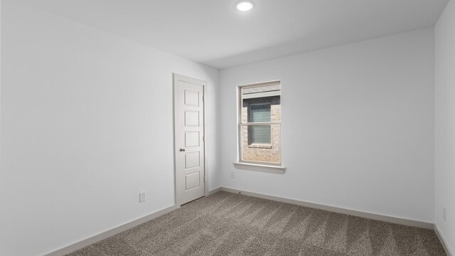 unfurnished room with recessed lighting, light carpet, and baseboards