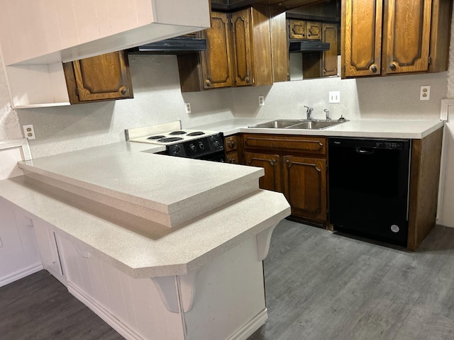 kitchen with sink, electric range, dark wood-type flooring, and black dishwasher