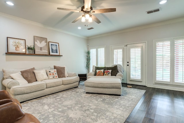 living room with a healthy amount of sunlight, ornamental molding, and dark hardwood / wood-style flooring