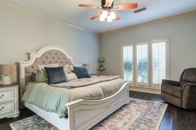 bedroom featuring a textured ceiling, dark wood-type flooring, ornamental molding, and ceiling fan