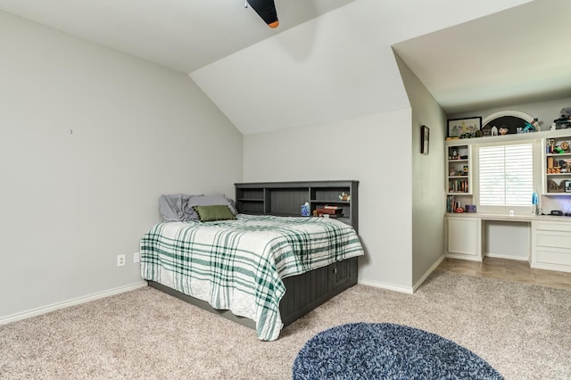 carpeted bedroom with ceiling fan and vaulted ceiling