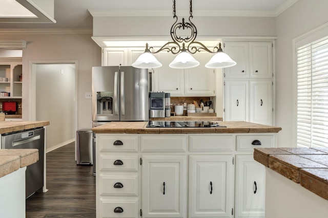 kitchen with ornamental molding, white cabinets, pendant lighting, stainless steel appliances, and backsplash