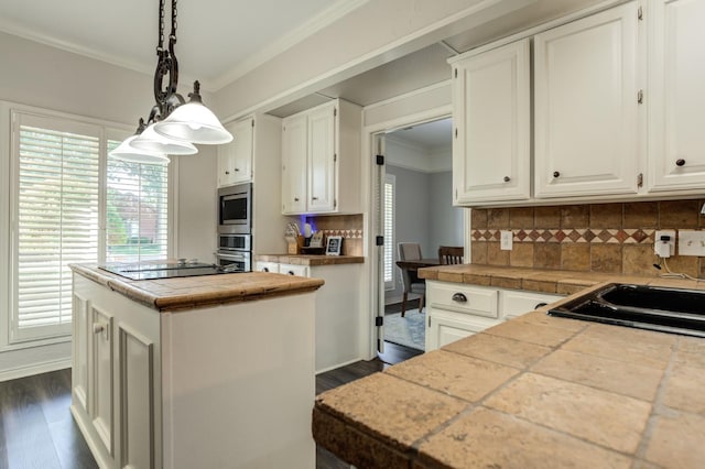 kitchen with white cabinetry, decorative backsplash, a center island, and appliances with stainless steel finishes