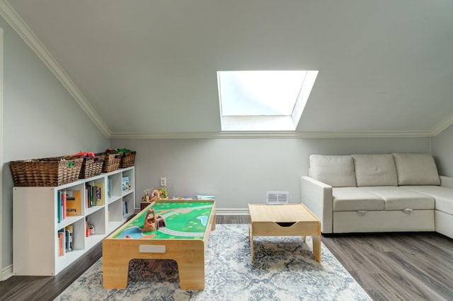 recreation room with wood-type flooring and lofted ceiling with skylight