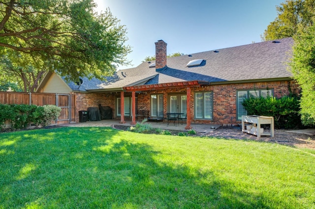 back of house featuring a pergola, a yard, and a patio