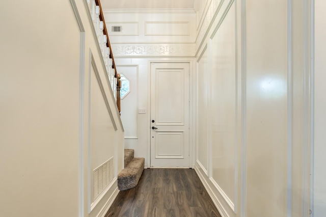 interior space with dark wood-type flooring and ornamental molding