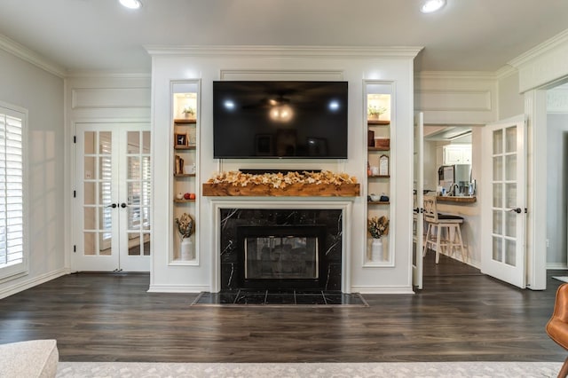 living room featuring dark hardwood / wood-style flooring, a fireplace, french doors, and a healthy amount of sunlight