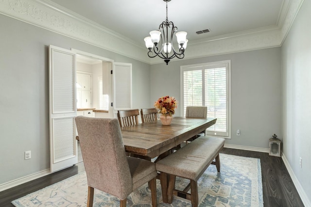 dining room featuring ornamental molding, dark hardwood / wood-style flooring, and a chandelier