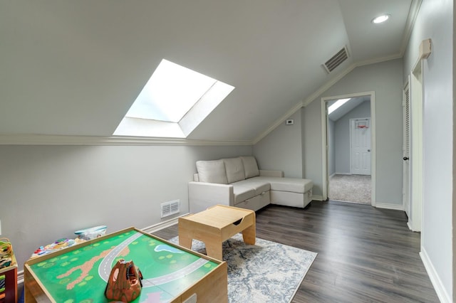 rec room with lofted ceiling with skylight and dark hardwood / wood-style floors