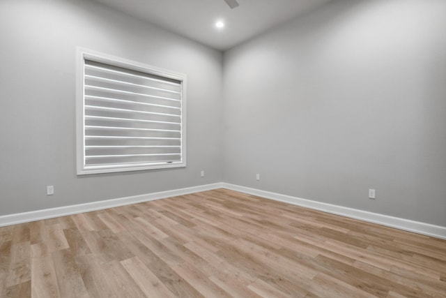 unfurnished room with ceiling fan and light wood-type flooring