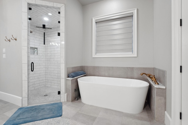 bathroom with tile walls, tile patterned floors, and shower with separate bathtub