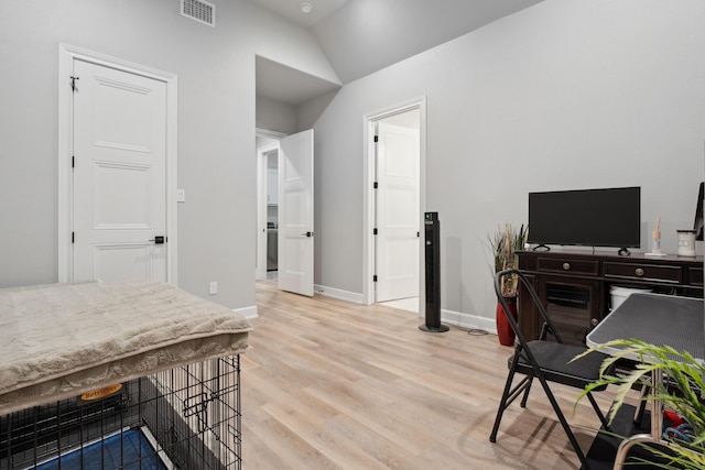 office area with vaulted ceiling and light hardwood / wood-style flooring