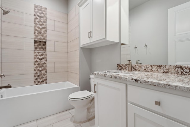 full bathroom with tiled shower / bath, vanity, and toilet