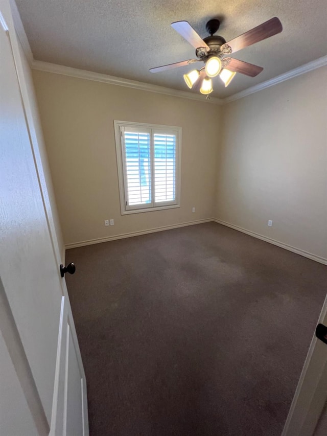 spare room with ceiling fan, ornamental molding, a textured ceiling, and dark colored carpet