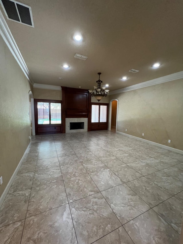 unfurnished living room with crown molding and a chandelier