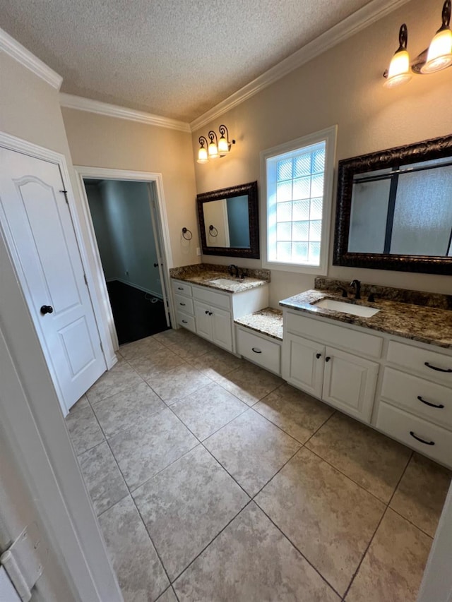 bathroom with vanity, crown molding, tile patterned floors, and a textured ceiling