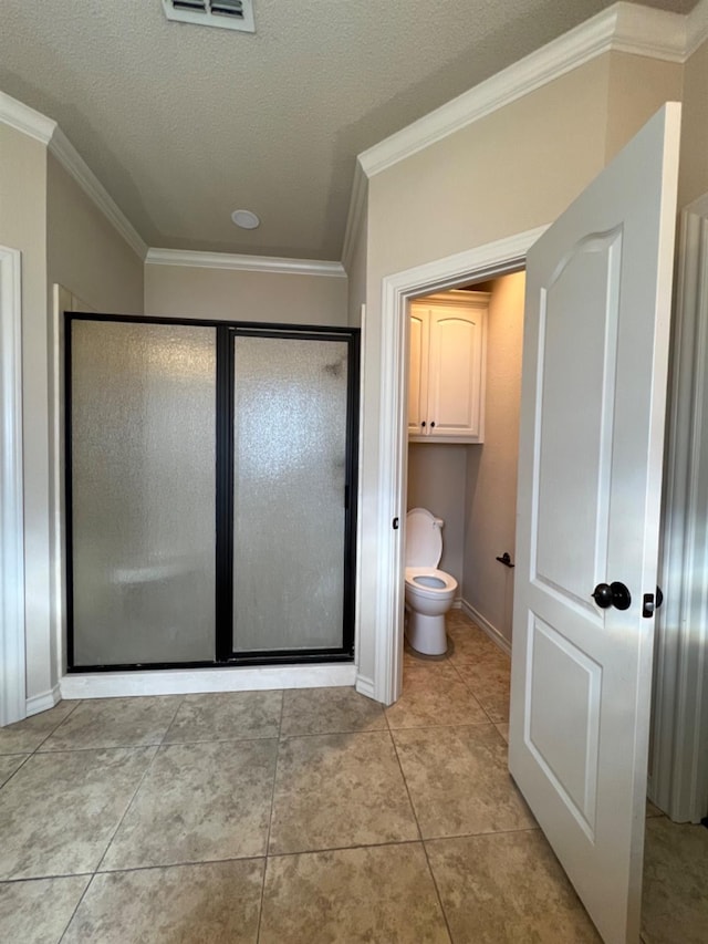 bathroom featuring crown molding, tile patterned floors, toilet, and walk in shower