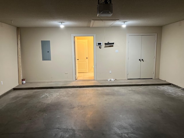 garage with a garage door opener and electric panel