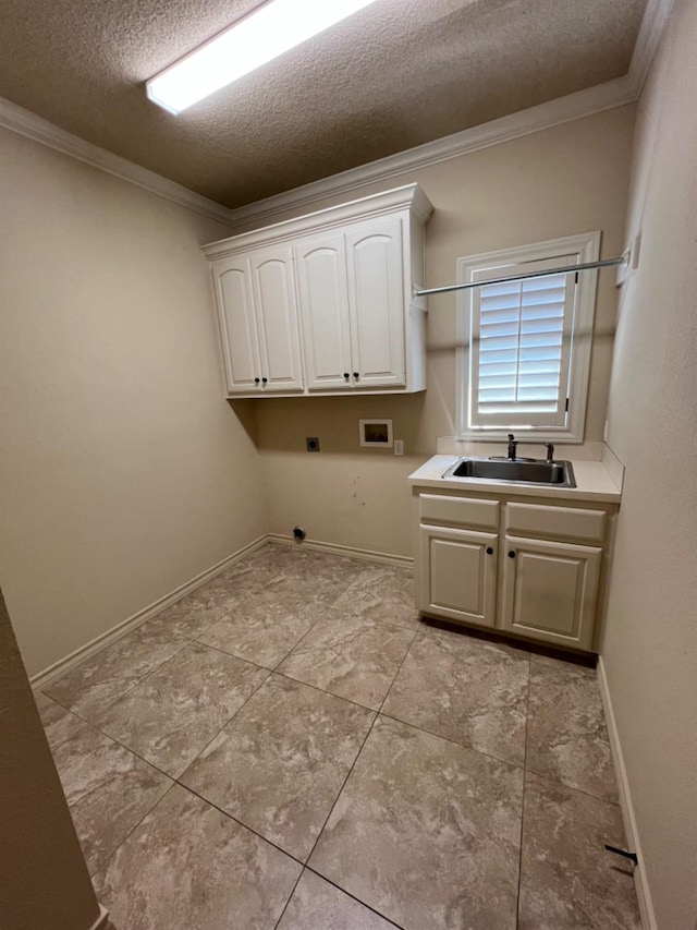 laundry area with washer hookup, sink, crown molding, and cabinets