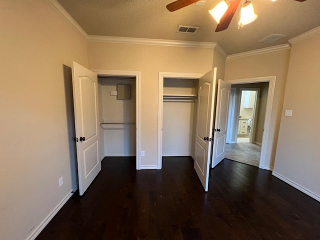 unfurnished bedroom featuring crown molding, ceiling fan, and dark hardwood / wood-style floors