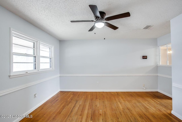 504 53rd St, Lubbock, TX 79404 - empty room with wood finished floors, a textured ceiling, and a ceiling fan